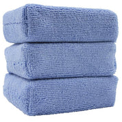 3 Pack 6" x 4" x 2"  black poly-sponge encased in a blue microfiber applicator.